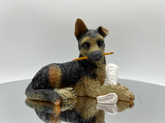 German Shepherd Cast Figurine, Paper Under Paw & Holding Pencil in Mouth. Very Highly Detailed. 3.75" Long X 2.5" High